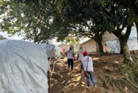 MSF staff walk up hill to mobile clinic