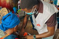 MSF doctors looking after children inside measles isolation unit at Um Sangour Refugees Camp, White Nile State.